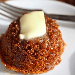 Mimi's Copycat Honey Bran Muffin on plate with fork and pat of butter melting on top of warm muffin.