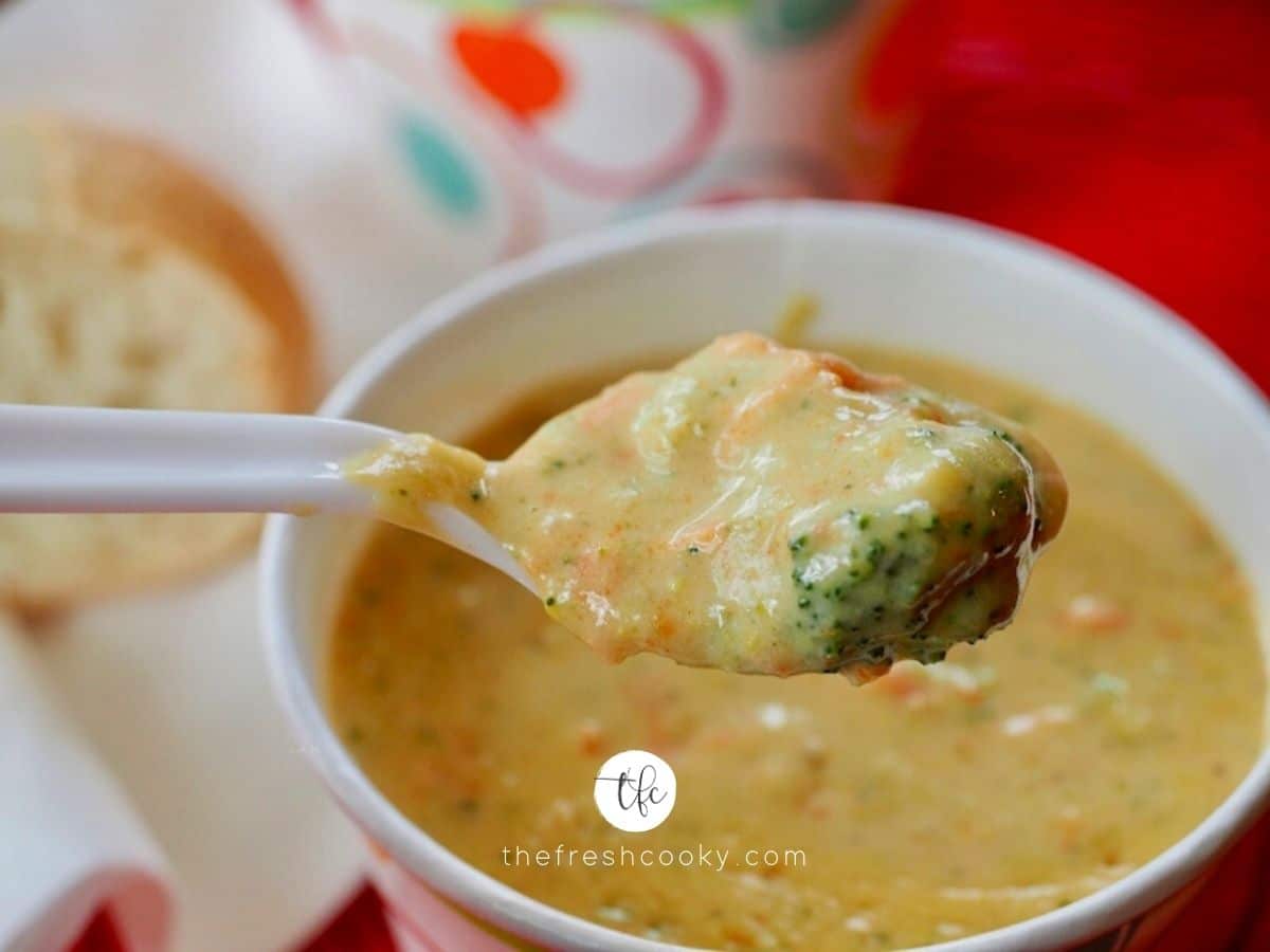 Facebook image of spoon filled with chunk broccoli cheese soup with soup in cup in background.