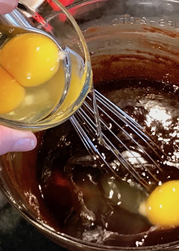 Pouring eggs into brownie mixture | www.thefreshcooky.com