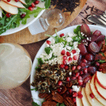Wild Rice Harvest Salad top down shot with two plates of bright, colorful wild rice salad.