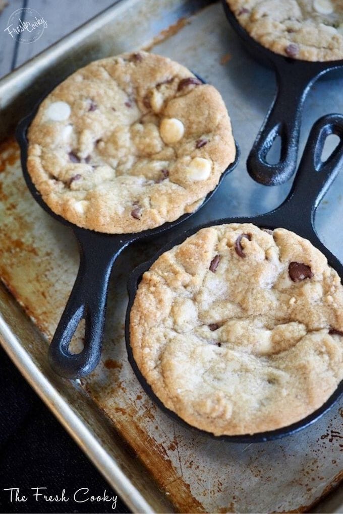 Close up of slightly golden baked chocolate chip cookies in mini skillets. https://www.thefreshcooky.com/key-lime-torte/