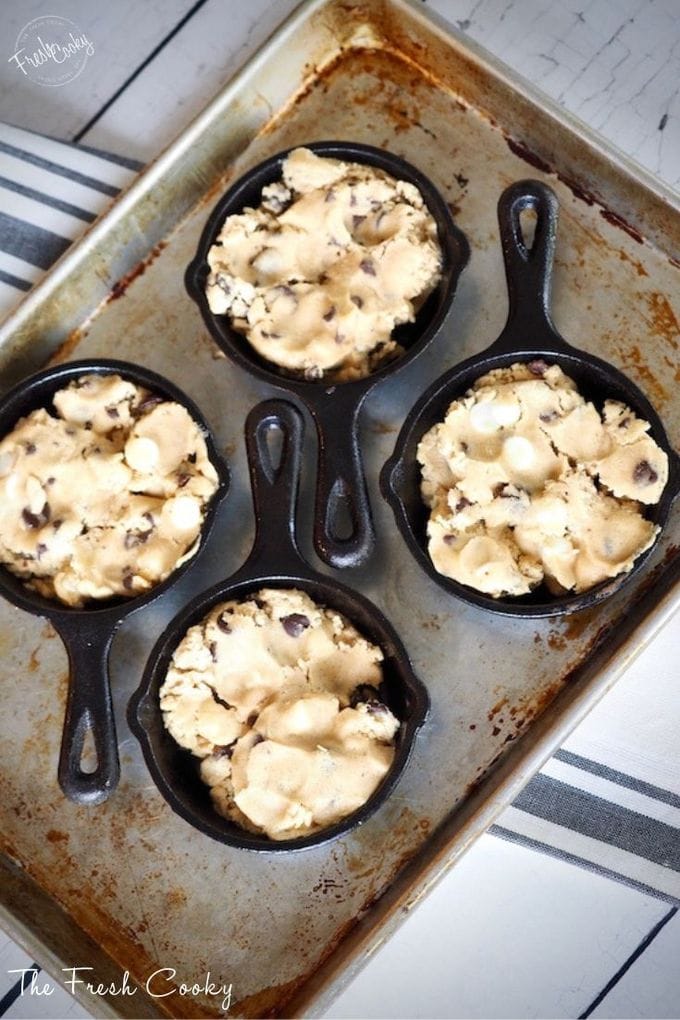Quarter Sheet pan with cookie dough pressed into mini skillets.