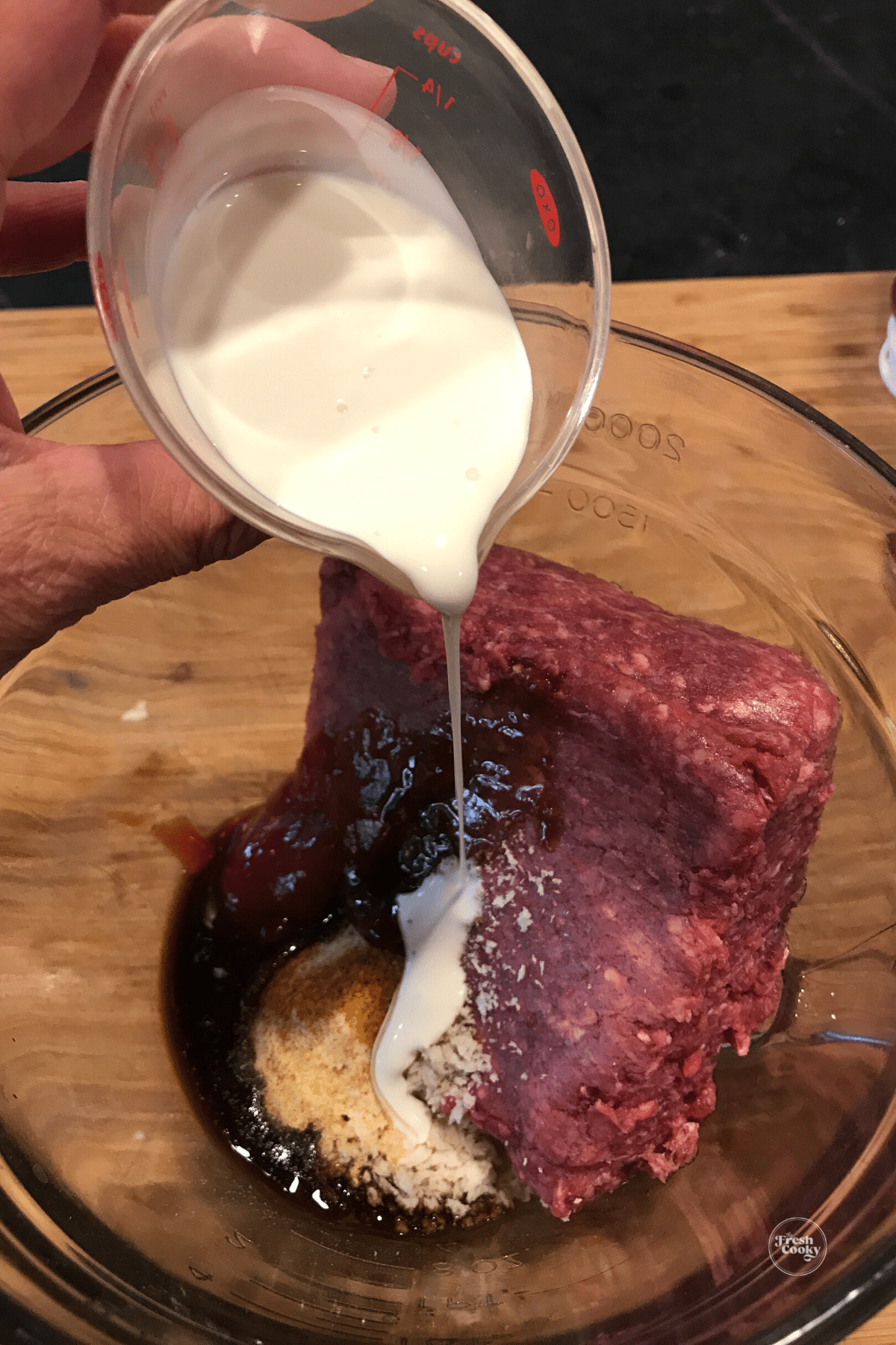 Pouring in cream to bison mixture.