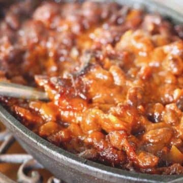 Cast Iron Pan filled with Cowboy baked beans with bacon.