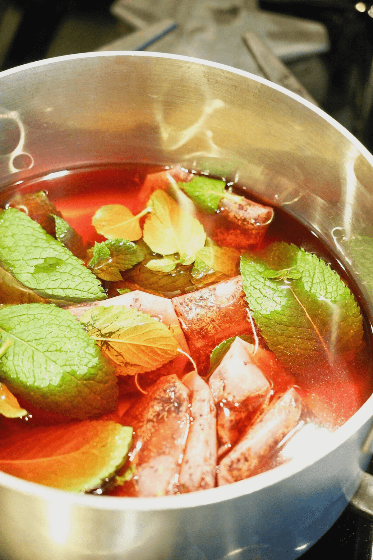 Tazo passion tea bags and mint in hot water.