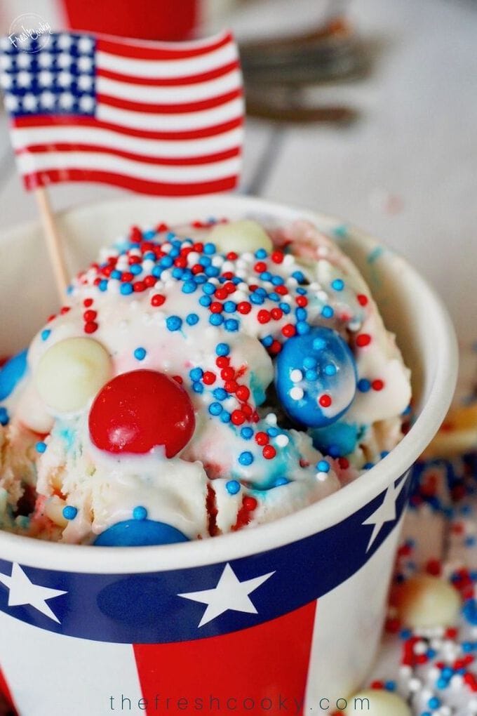 Scoop of no churn red, white and  blue Patriotic no churn ice cream in a patriotic star spangled cup.