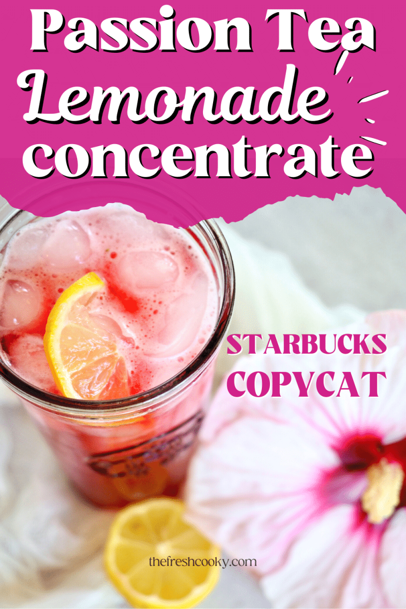 Pin for Passion Tea Lemonade Concentrate a starbucks copycat recipe with top down shot of glass filled with passion tea lemonade with a twist of lemon, hibiscus flower and half of lemon nearby.