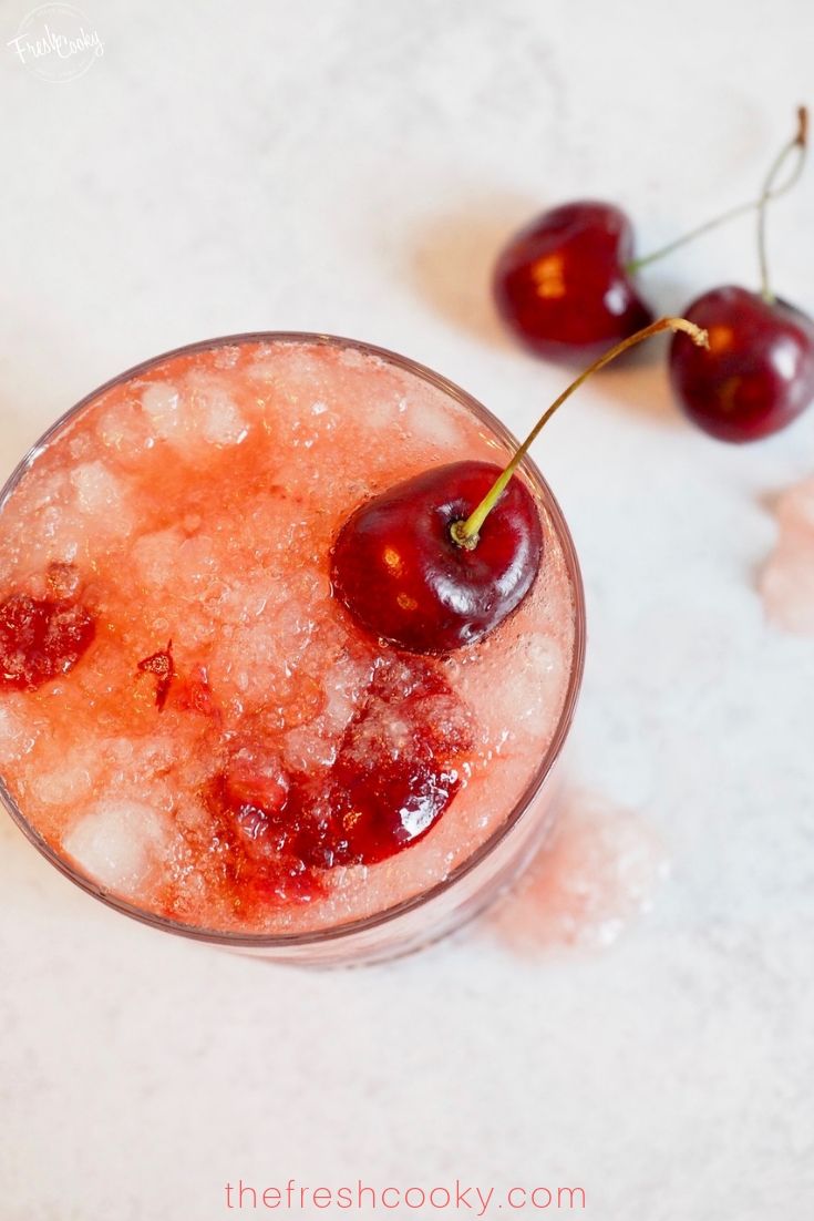 glass full cocktail with cherry on top