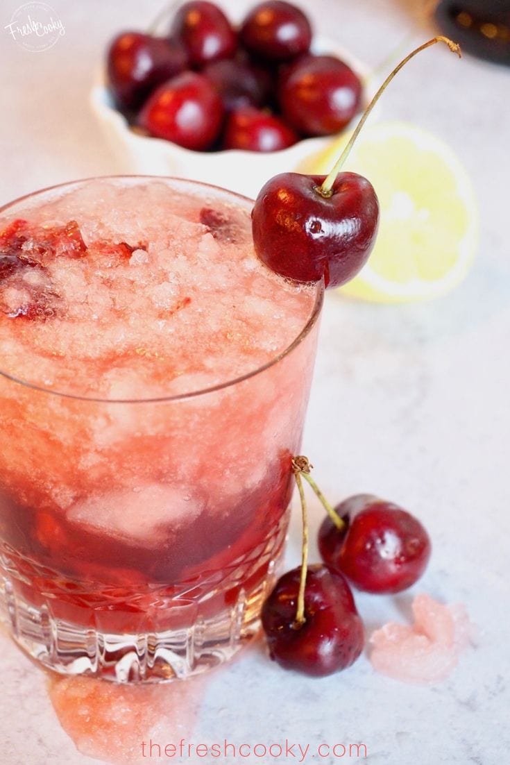 glass full cocktail with cherry on top