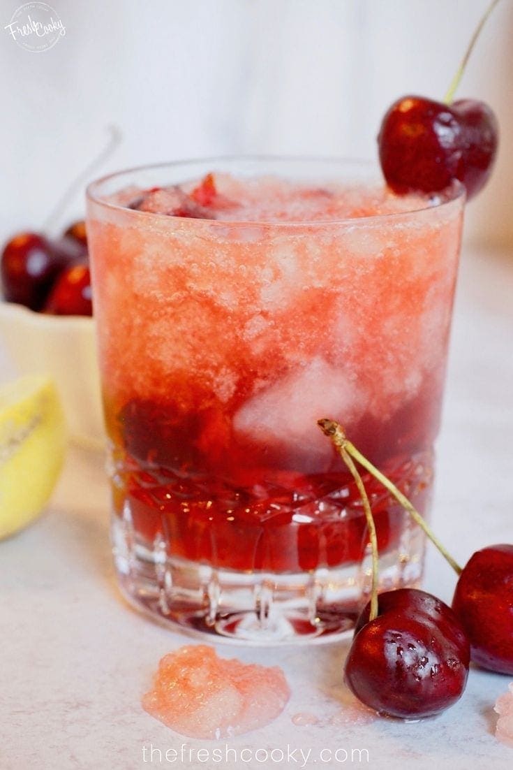 glass full cocktail with cherry on top