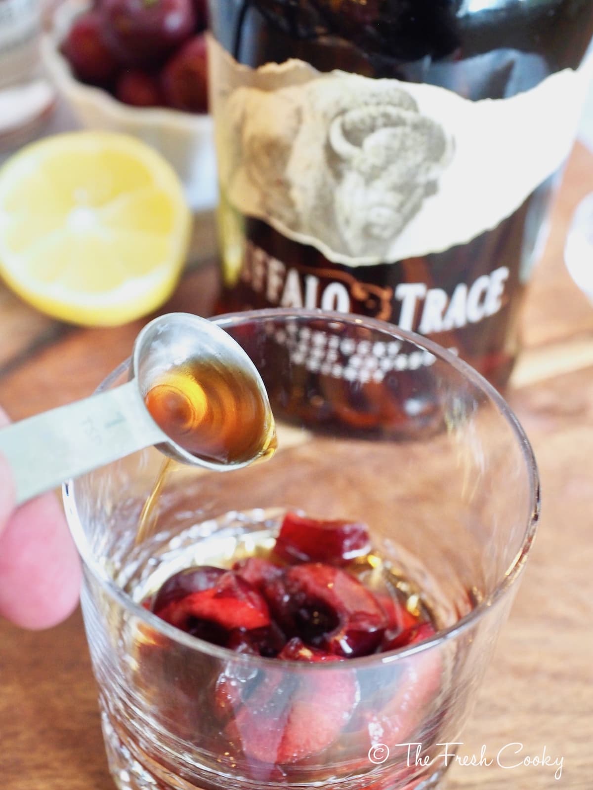 Adding bourbon vanilla to Cherry Bomb drink.