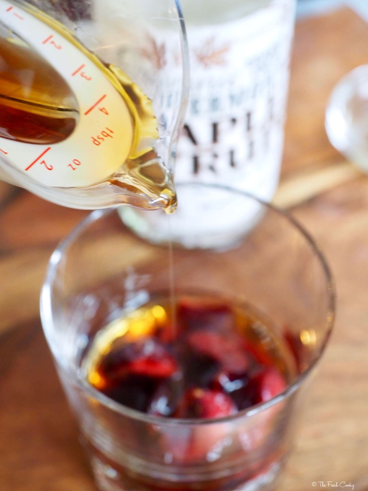 Adding maple syrup to cherry bomb cocktail.