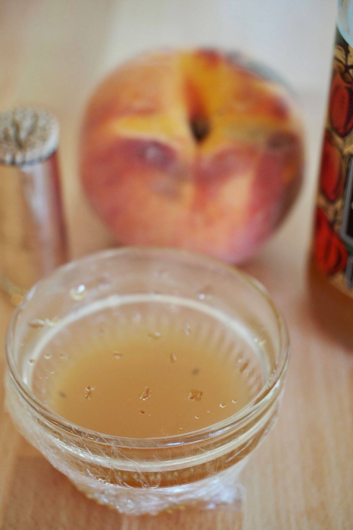 Fruit fly trap in small ramekin with dead fruit flies inside.