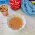 Making your own gnat trap with apple cider vinegar.