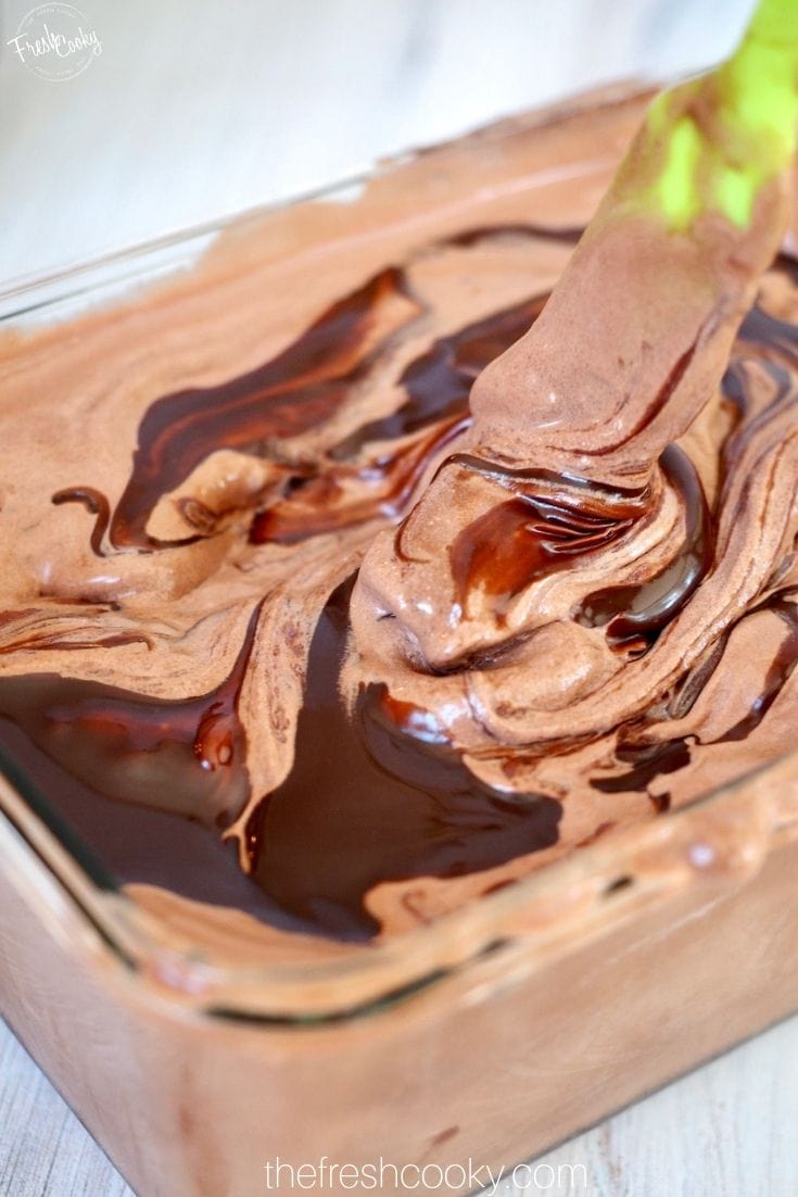 Chocolate soft ice cream with swirls of fudge sauce in it. 