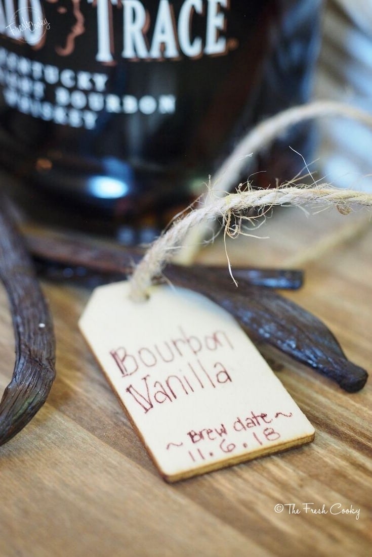 wooden tag for bourbon vanilla extract with beans and bourbon bottle | thefreshcooky.com