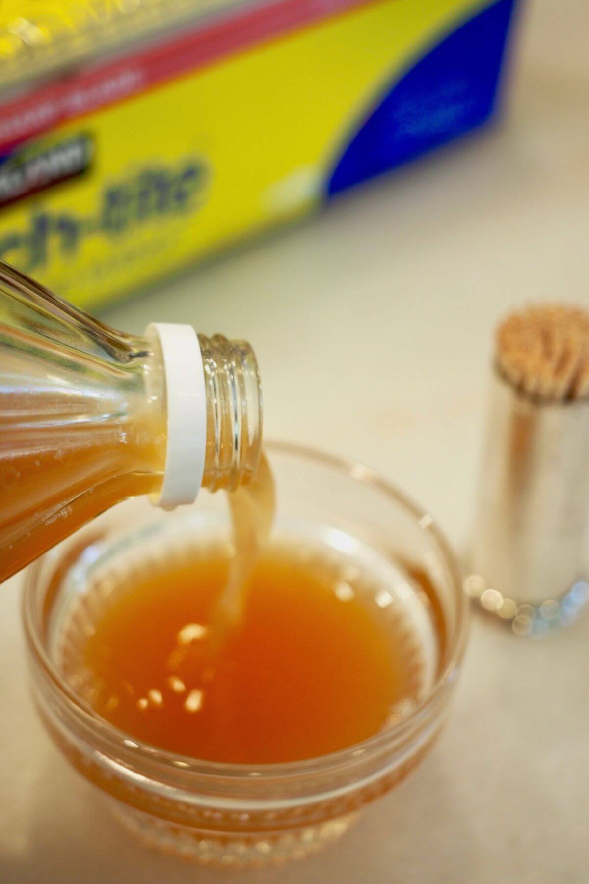 Pouring vinegar into a ramekin for gnat trap.