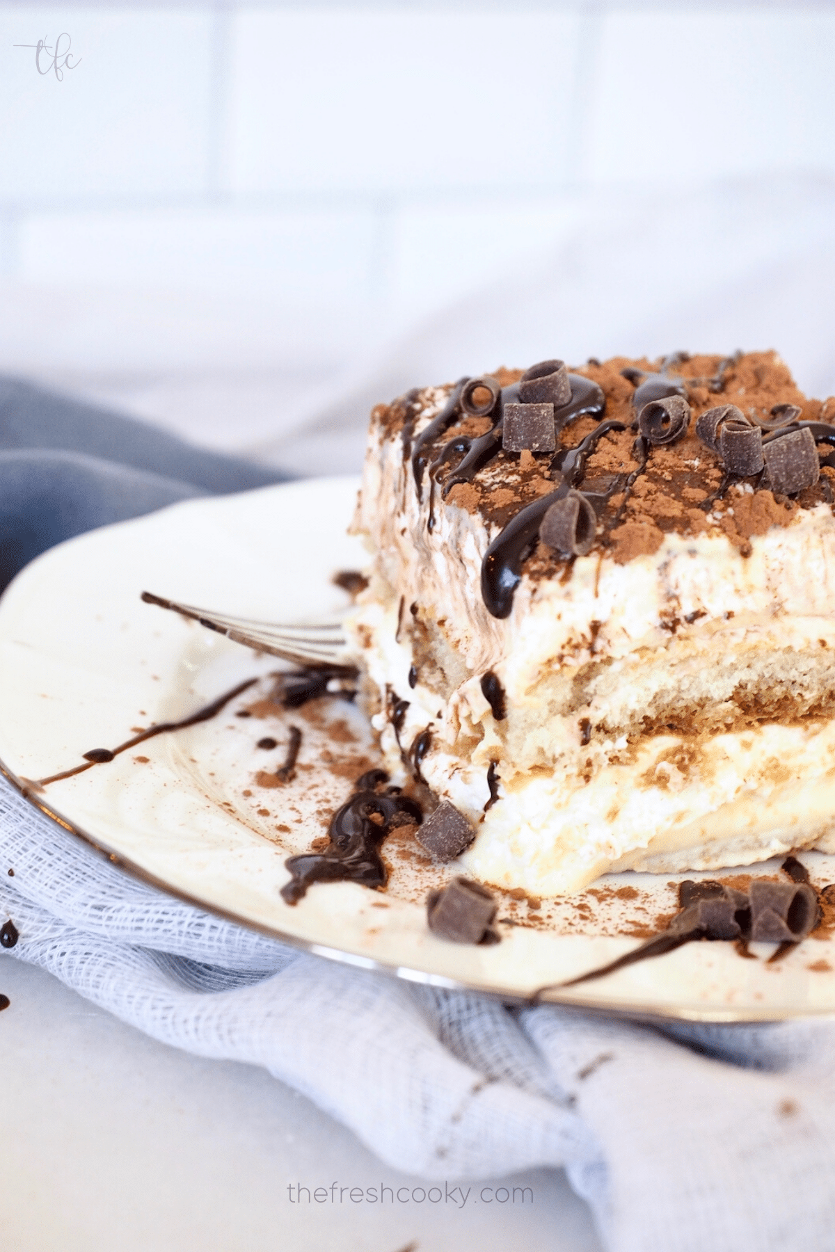 Classic Traditional Tiramisu Recipe with slice on plate showing beautiful layers fo this no bake dessert.