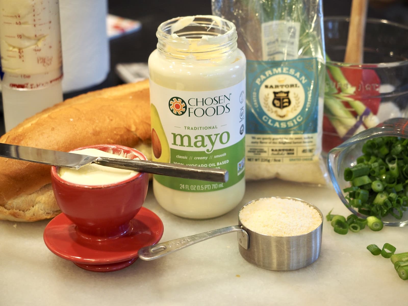 ingredients for cheesy bread spread; French bread, mayo, butter, parmesan cheese and green onions chopped. | thefreshcooky.com