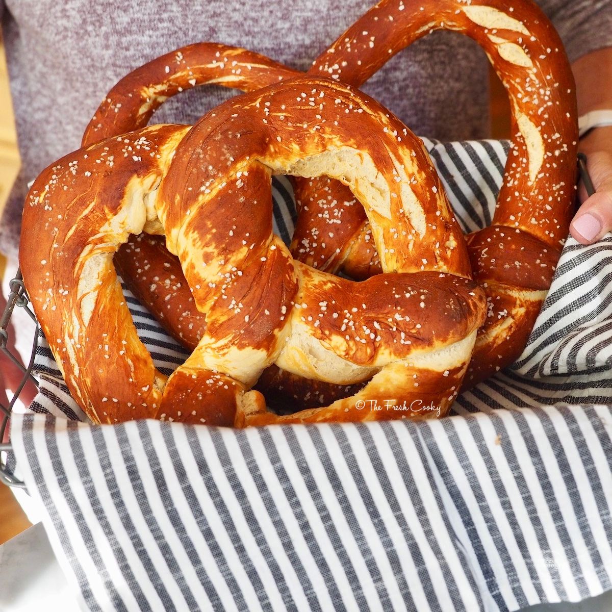 Giant soft pretzels in basket for serving.