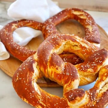 Bavarian pretzels, giant-sized on a cutting board.