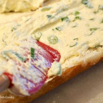 Evenly divide the mayo and cheese mixture between the two halves.
