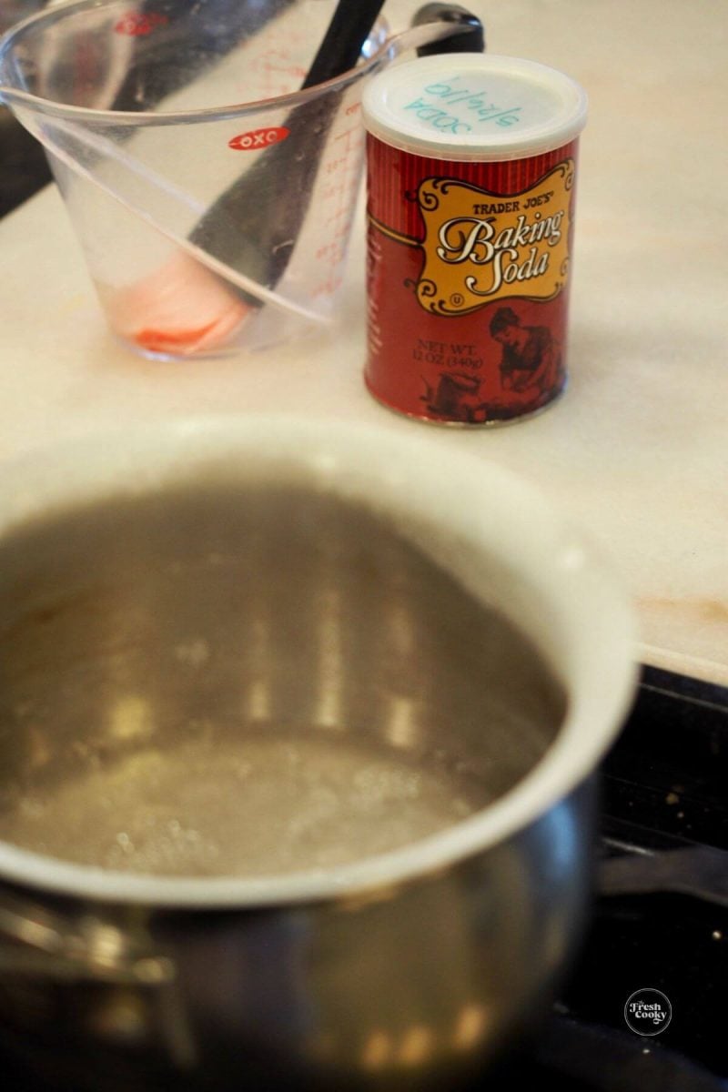 Combine baking soda and water and simmer. 