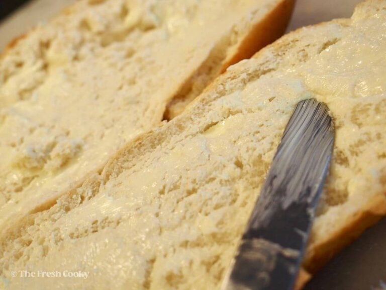 Smear the butter in a thin layer on the french bread.