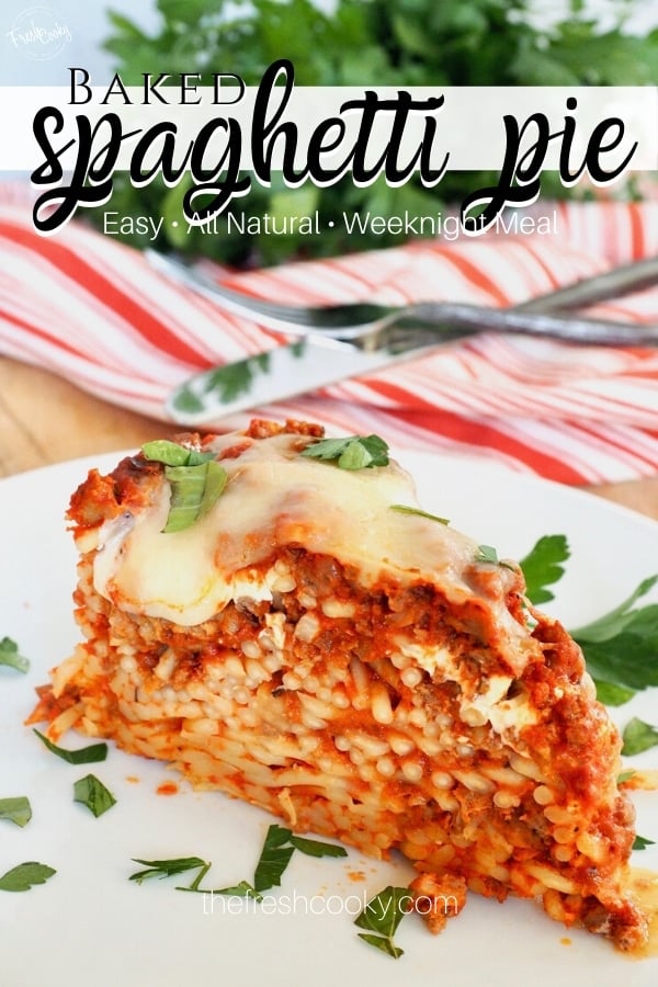 Easy baked spaghetti pie pin with wedge of pasta pie on white plate with fork and knife behind.