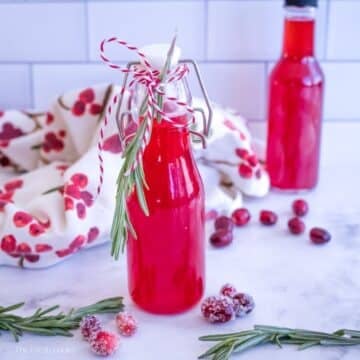 Bottle of Cranberry Simple syrup with another bottle in the background.