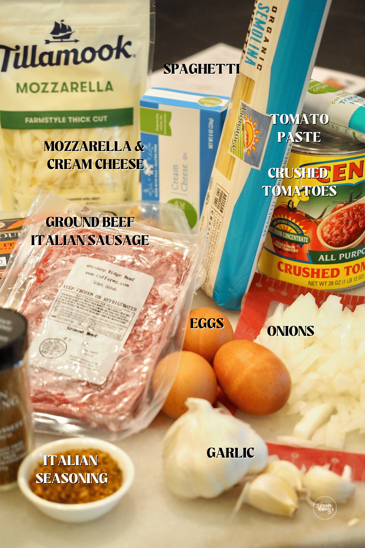 Labeled ingredients for baked spaghetti pie.