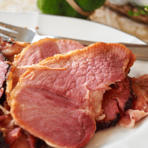 Coca Cola Ham recipes with ham slices on plate with serving fork.