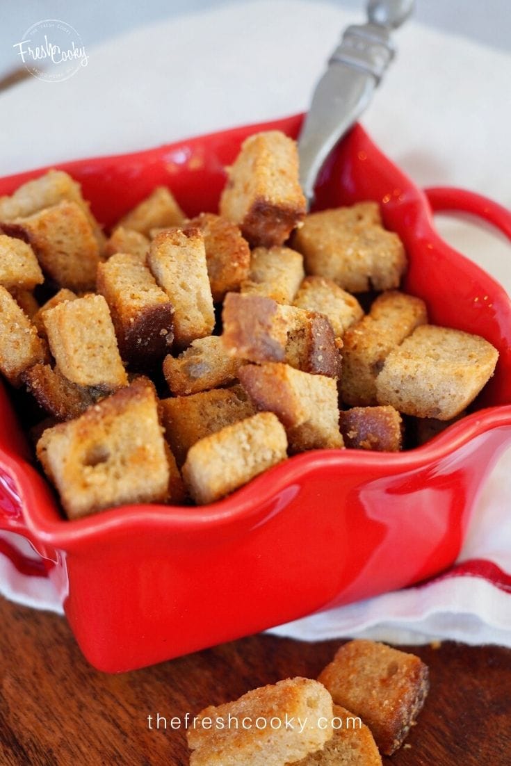 Crispy buttery croutons in red container. 