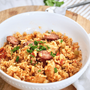 Square image of bowl filled with Instant Pot Jambalaya with chicken and sausage.