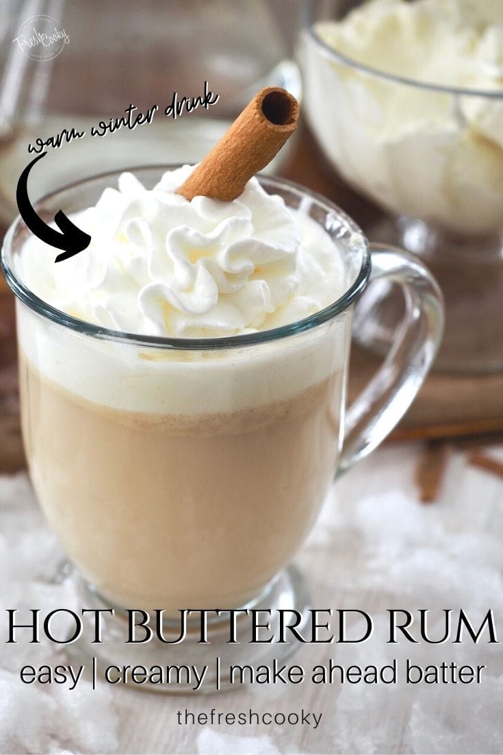 Pinterest image with glass mug filled with hot buttered rum topped with whipped cream and a cinnamon stick. 