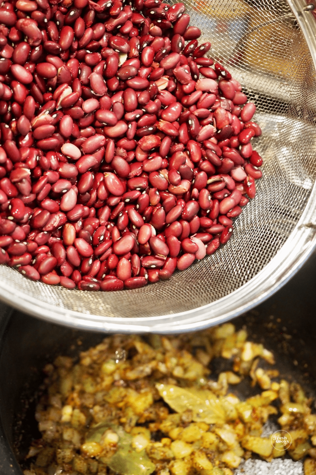 Rinsed red beans going into slow cooker.
