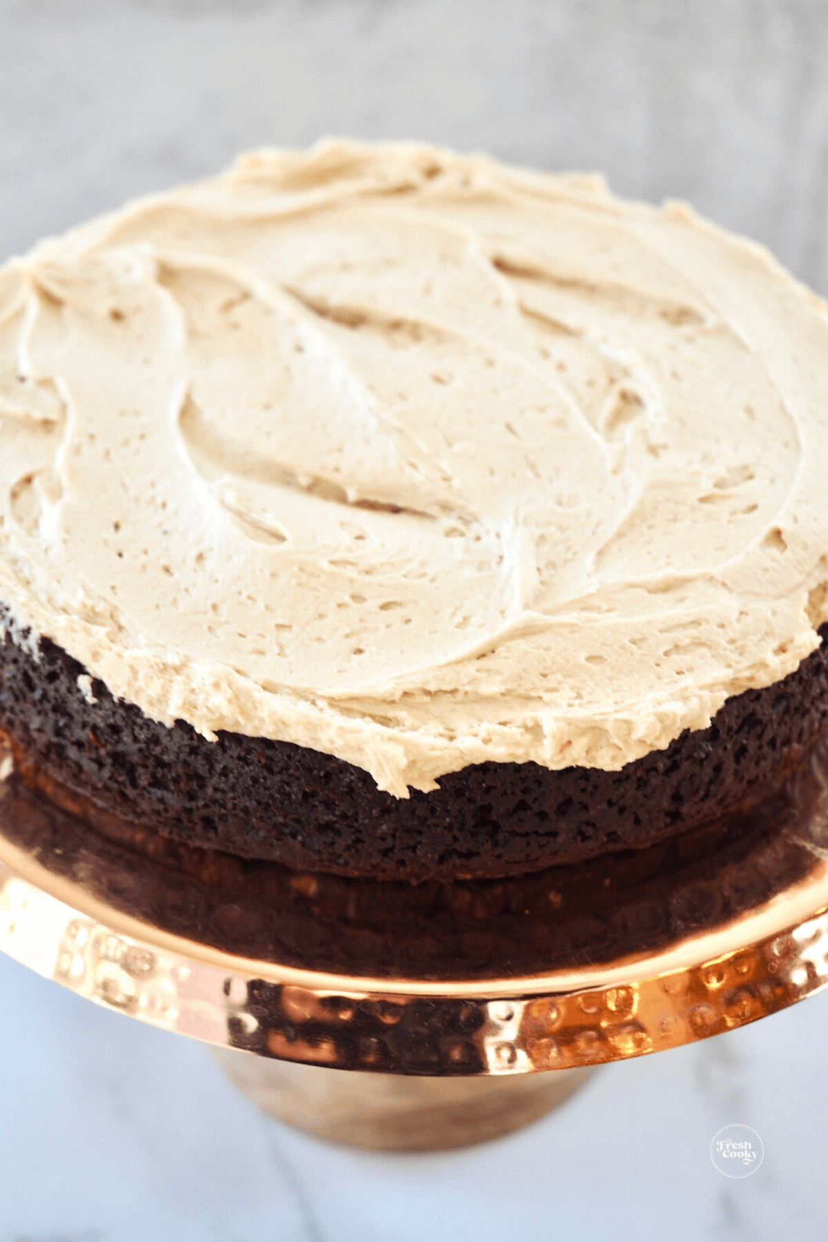 Chocolate Guinness cake on copper cake stand, topped with Irish buttercream.