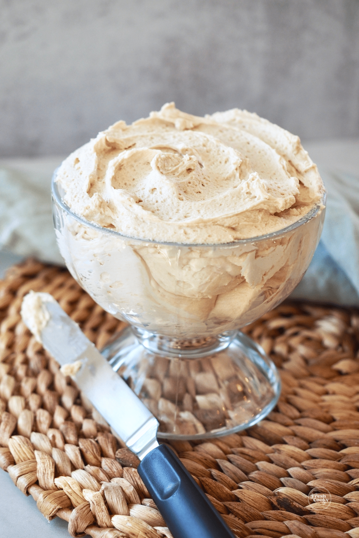 Baileys Irish buttercream frosting in bowl with off-set spatula.