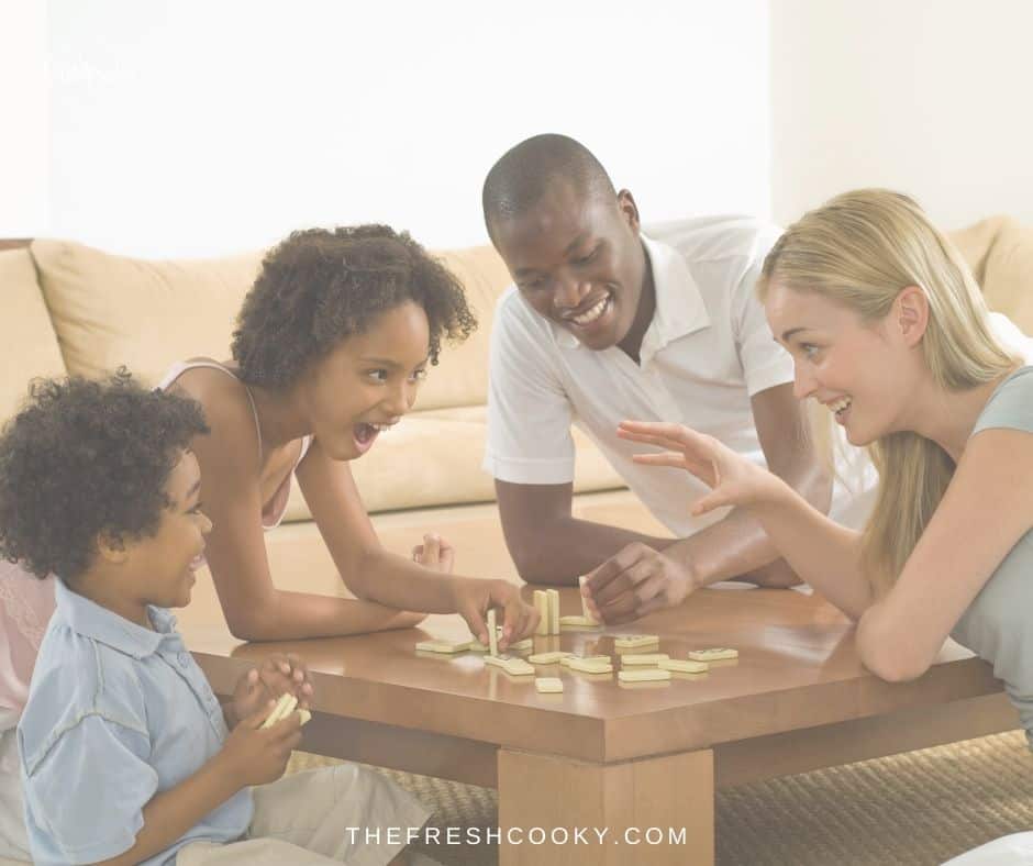 Family playing a game together in the family room. 