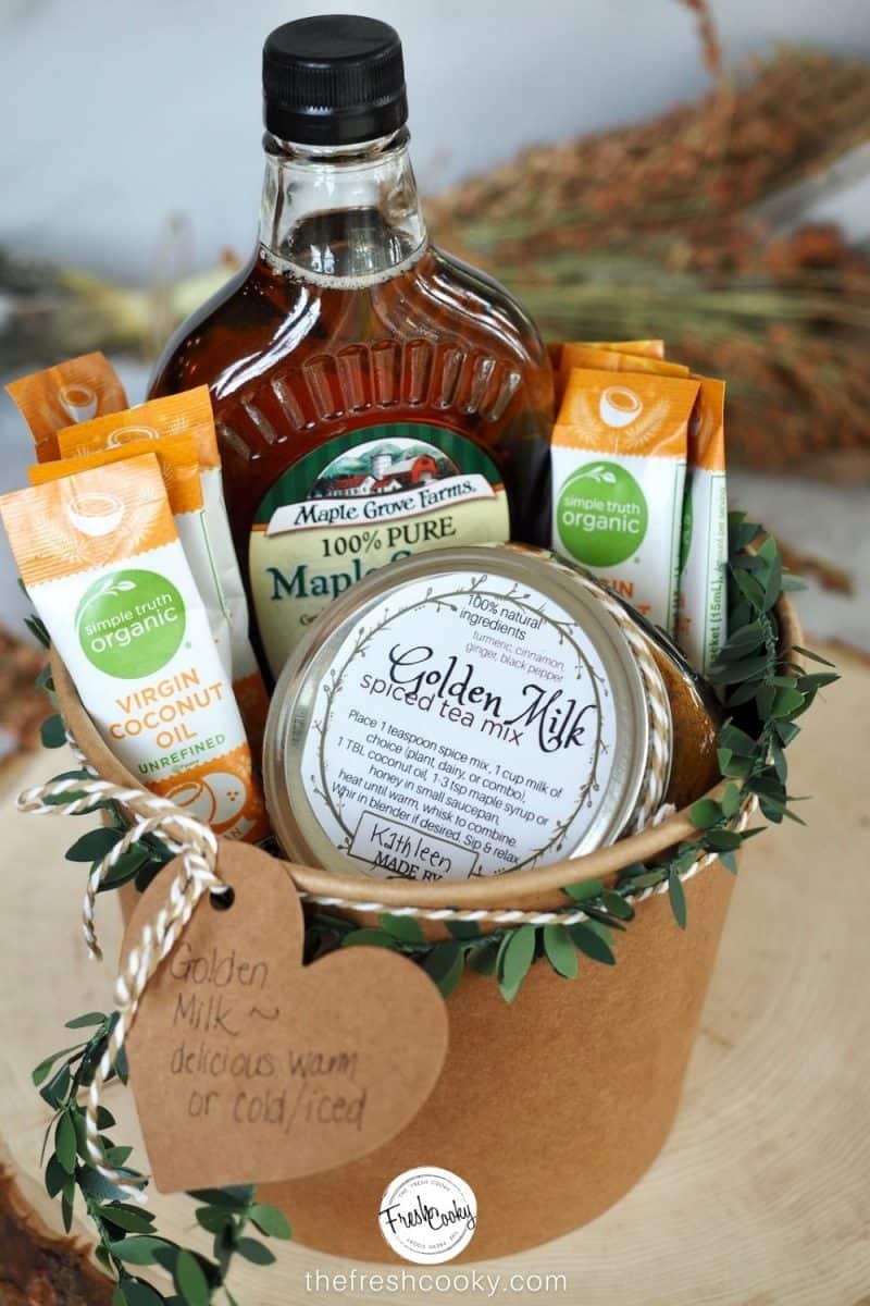 Golden Milk Spice Mix gift basket, filled with the spice mix in a jar, packets of coconut oil and maple syrup in a kraft paper bucket.