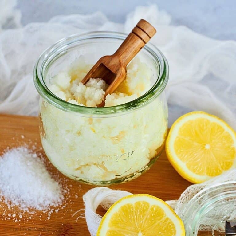 Lemon antibacterial hand scrub in a pretty jar with a wooden scoop.