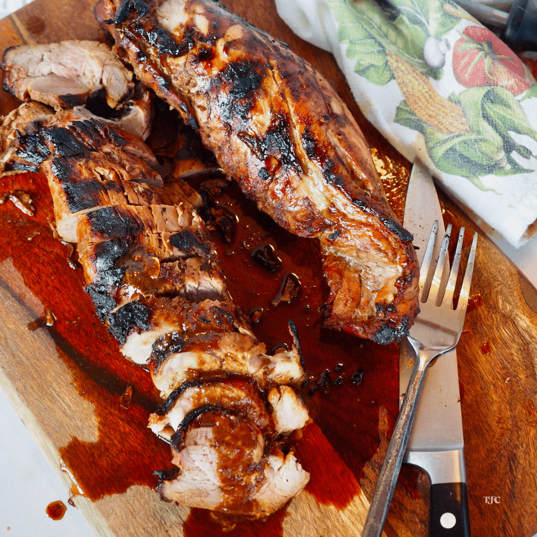 Asian Pork Tenderloin sliced and juicy on cutting board.