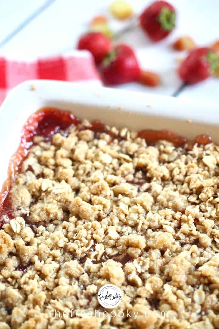 Close up of strawberry rhubarb crumb bars in square baker.