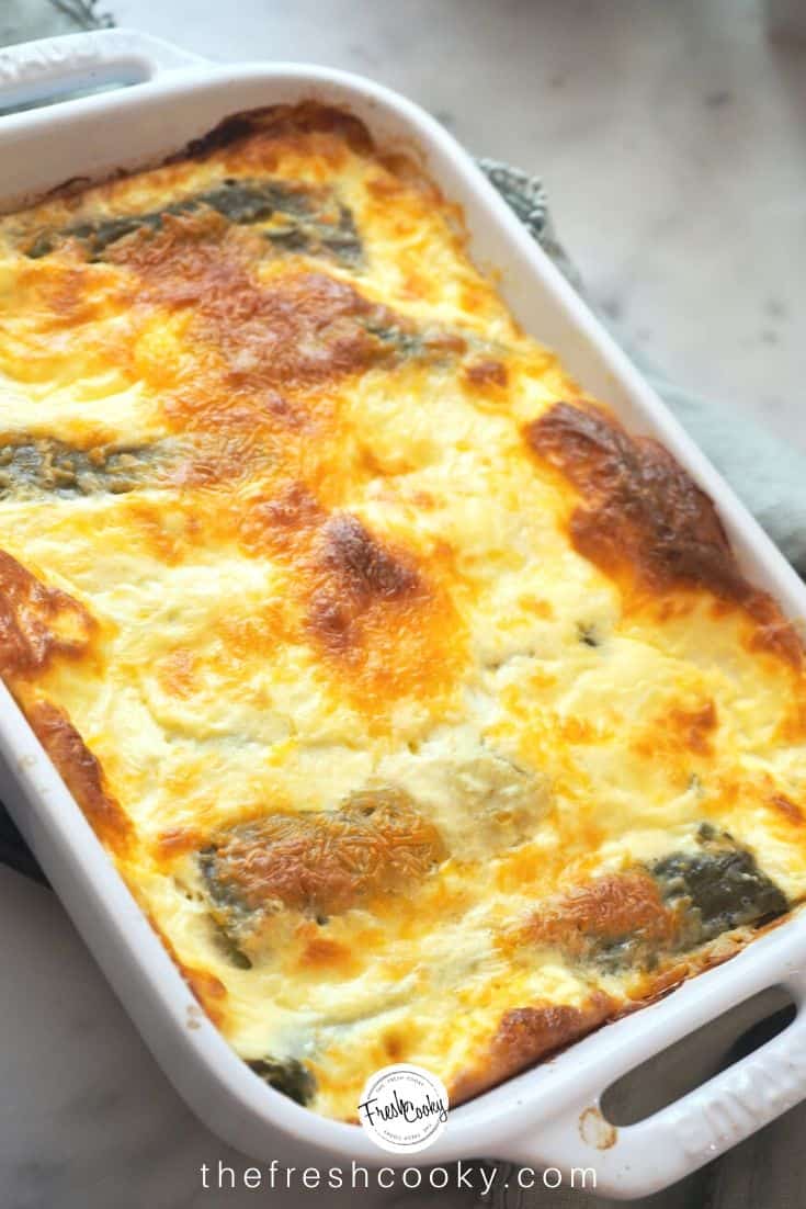 A casserole dish with baked chile rellenos, melty cheese, golden brown on top with a fluffy egg souffle type mixture. | The Fresh Cooky