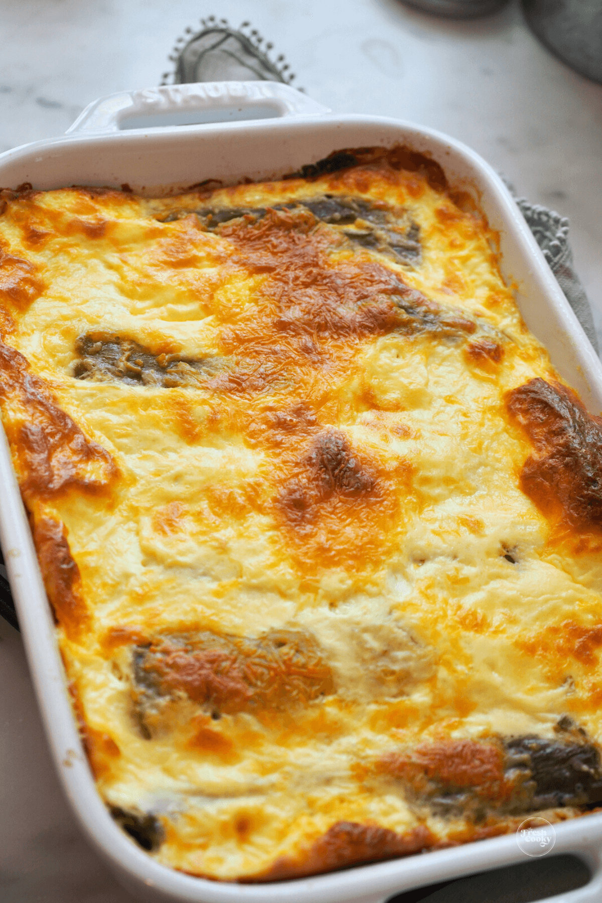 Crispy baked chile relleno casserole in Staub baking dish. 