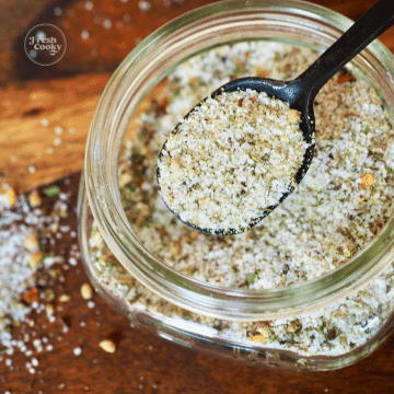 Carrabba's Grill seasoning square image with spoon in small jar of seasoning.