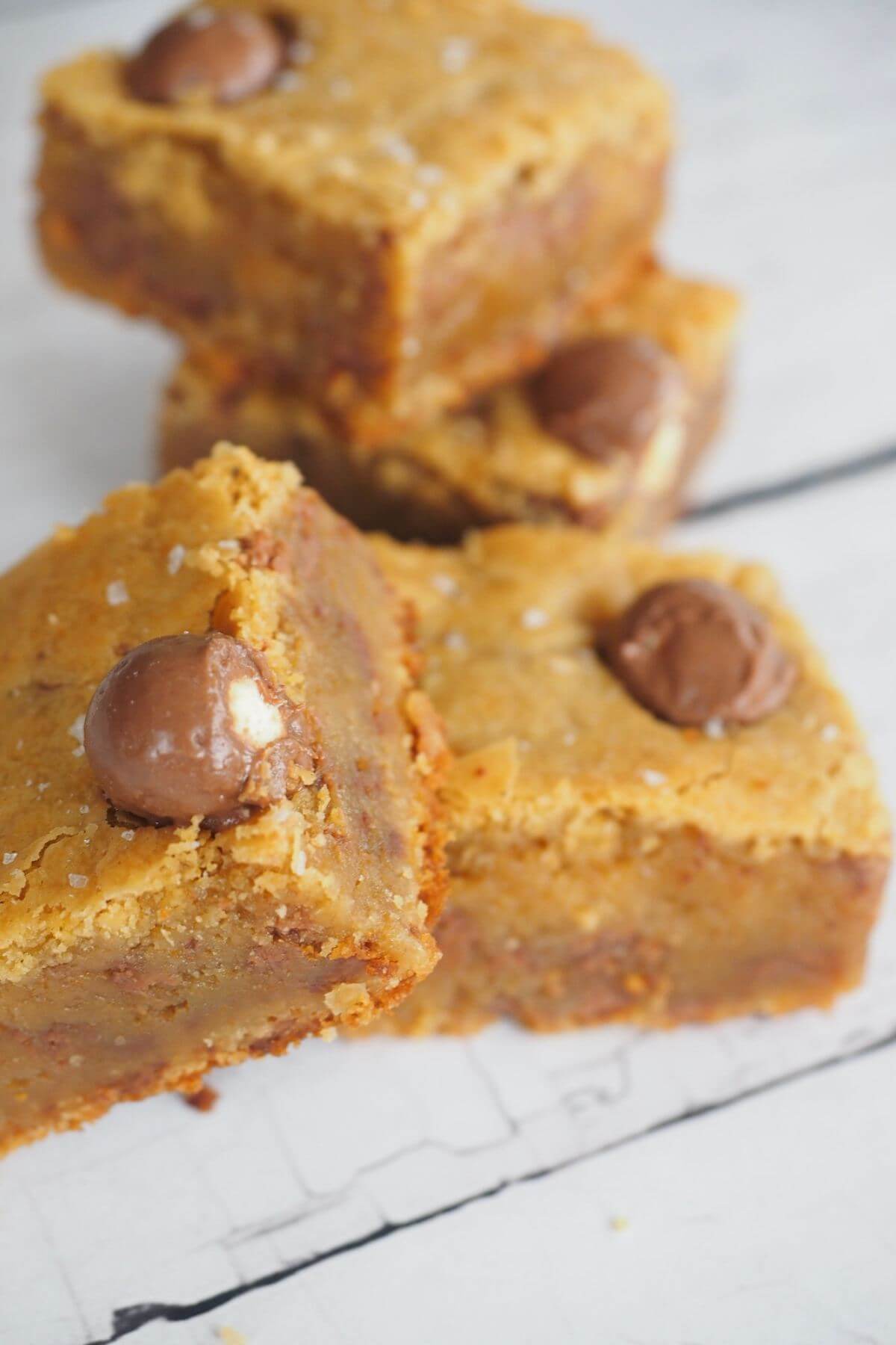 Blondies made with whoppers malted milk balls.