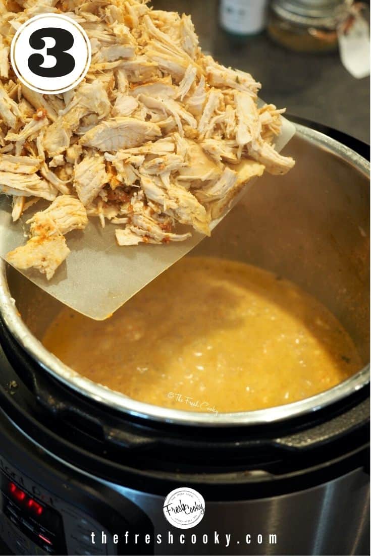 Shredded Chicken on flexible cutting board going into Instant Pot