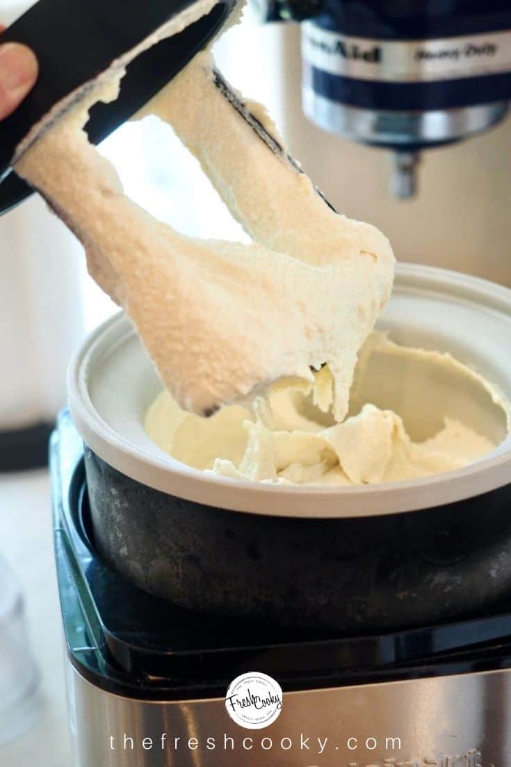 Pulling out the blade from the ice cream machine, covered in fresh, soft vanilla ice cream