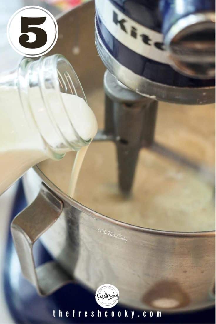 pouring in heavy whipping cream into bowl of stand mixer